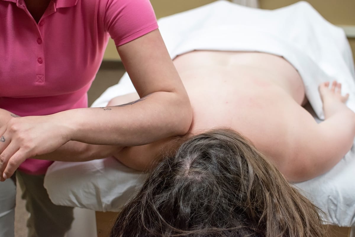 A therapist working through a patient's shoulder