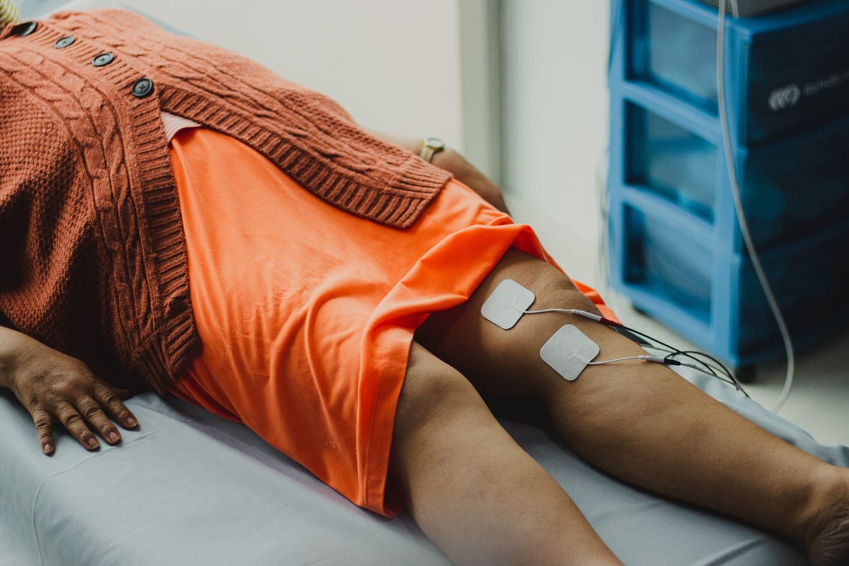 IFC electrode pads placed around a patient's knee